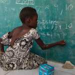 Girl writing on chalkboard in Brazzaville, Congo